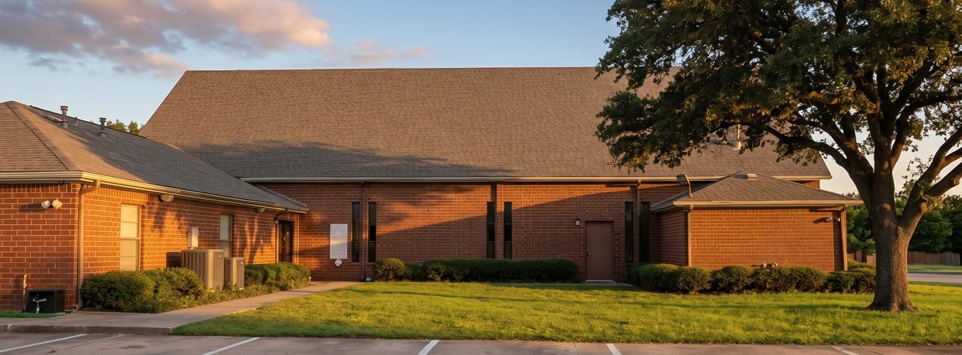 Exterior of the Islamic Center of Southlake campus surrounded by trees at golden hour